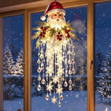 Pendente de Natal com Papai Noel, cascata de luzes LED e detalhes transparentes junto à janela